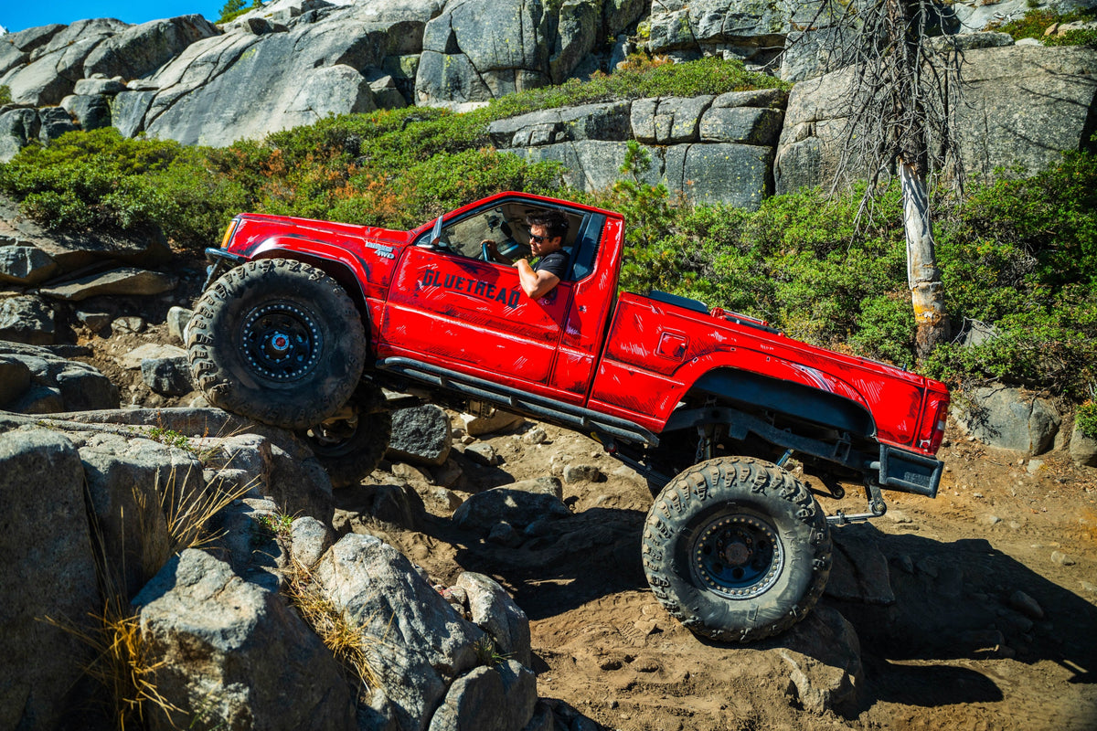 GlueTread red pickup crawling over boulders on the Rubicon Trail