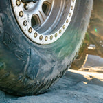 Close-up of a tire sidewall gluetread patch with treads on a rocky surface