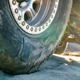 Close-up of a tire sidewall gluetread patch with treads on a rocky surface