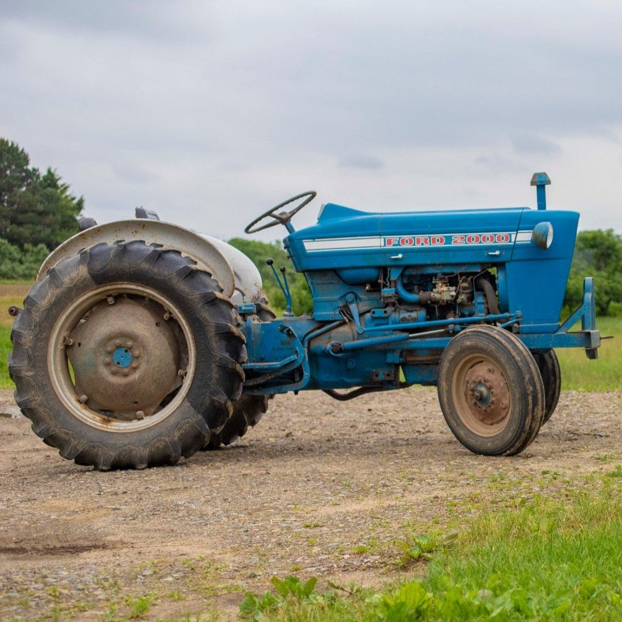 Blue farm tractor in a field