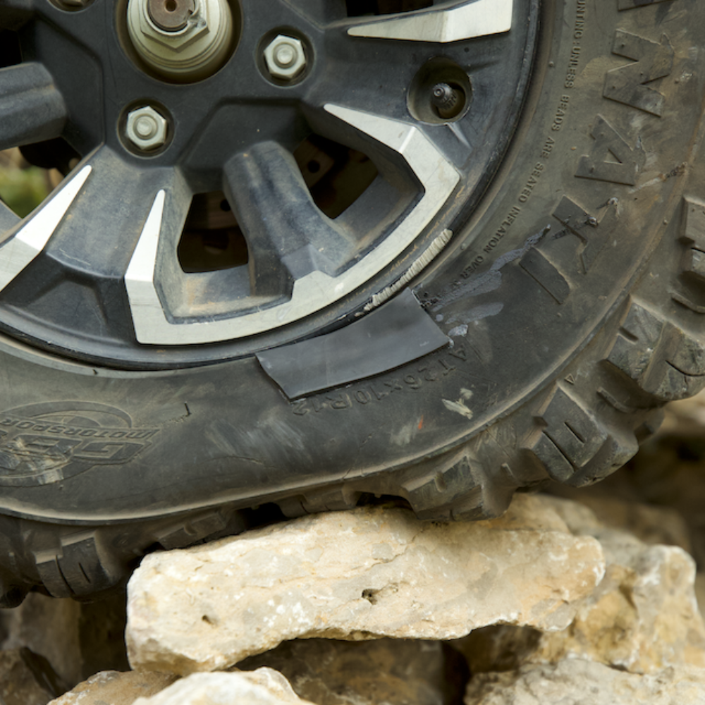 Off-road tire with a GlueTread patch on a rocky terrain