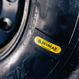 Close-up of a tire with a Blutrebaé label on a blurred background